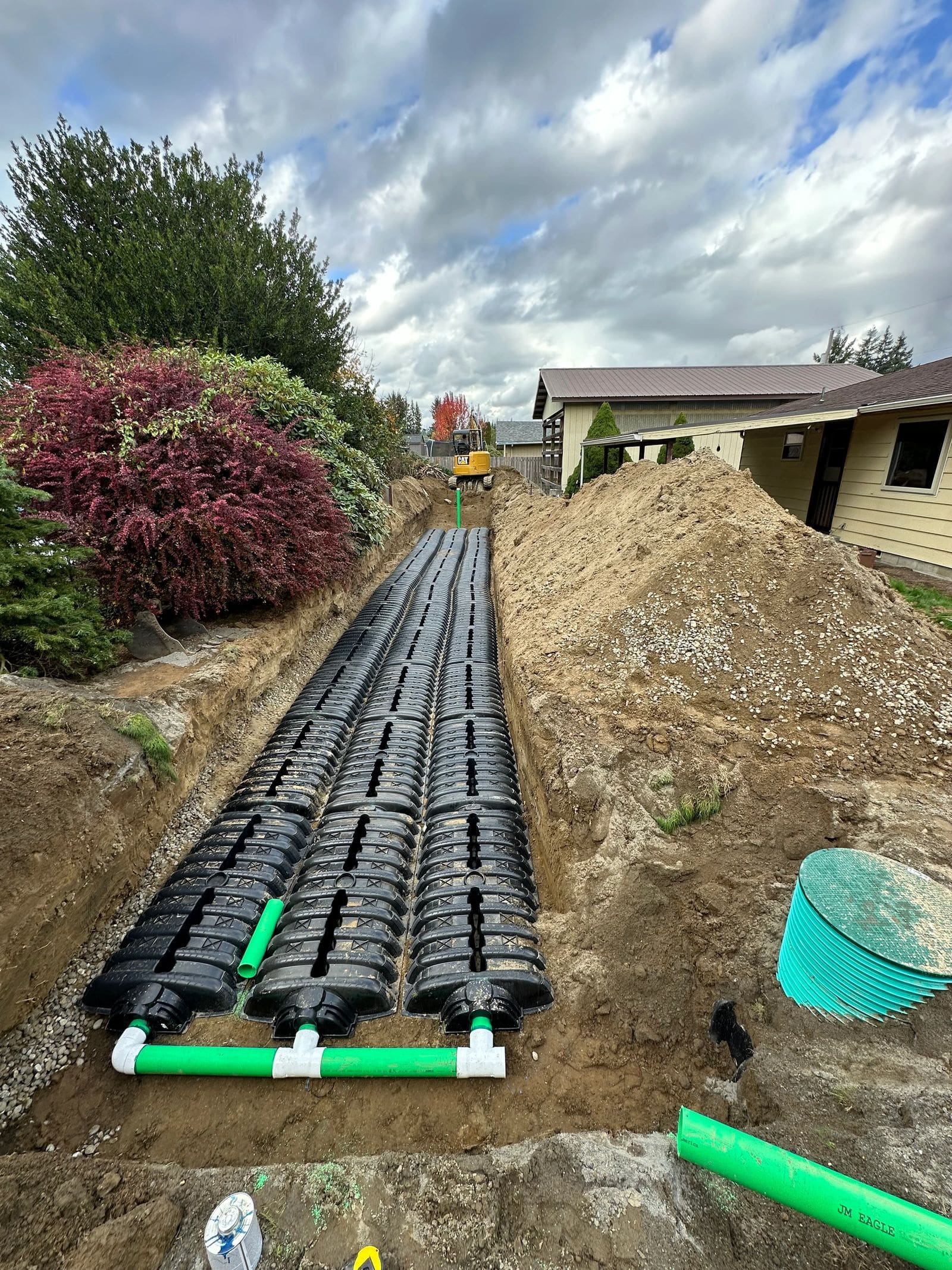 Drainfield chambers laid out in a trench during installation.